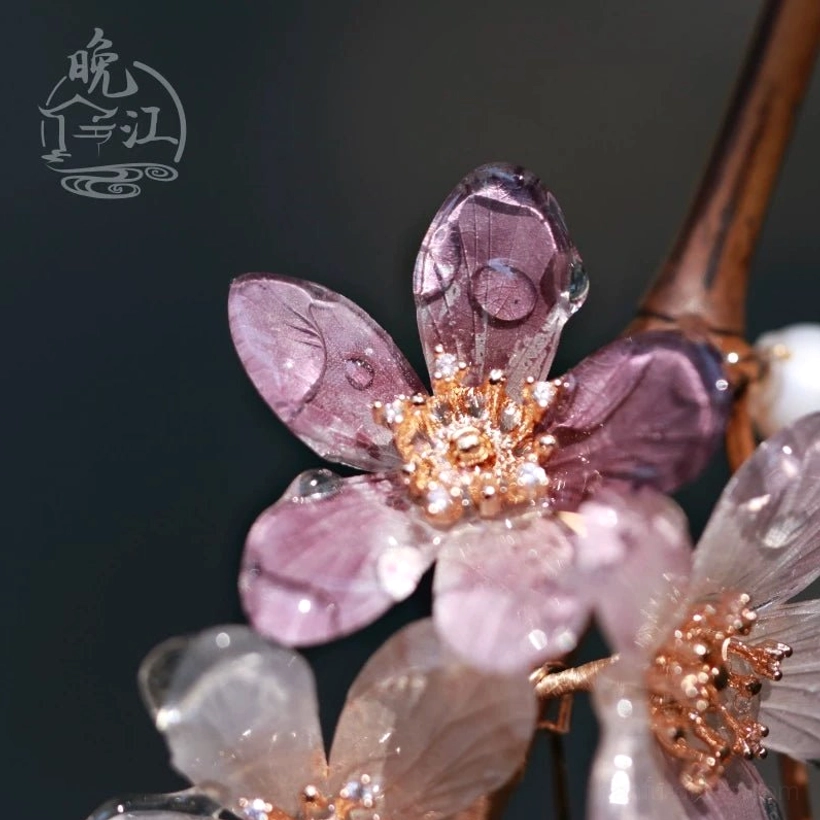 Close-up of deep purple translucent cherry blossom flowers with detailed petal texture and rose-gold-tone centers on a Chinese hair stick