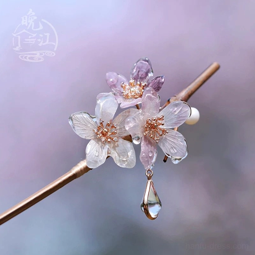 Polar Night cherry blossom Chinese hair stick with translucent white and light purple flowers, pearl-like bead and teardrop crystal tassel displayed on a wooden branch