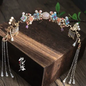 Pond Fairy Hanfu floral hair crown flat lay with gold-tone framework, colorful flower beads, pink center gem, and dangling pearl tassel chains