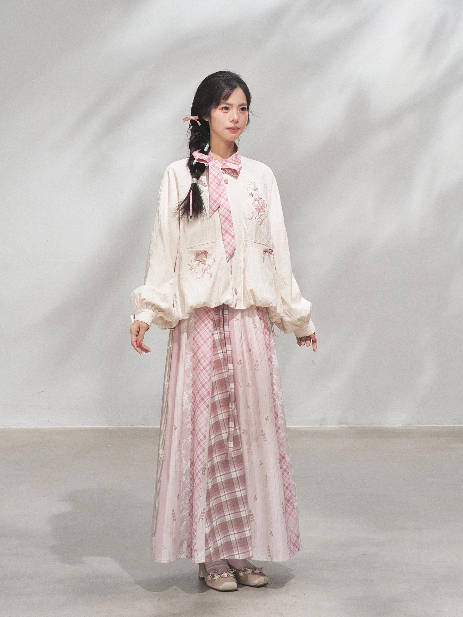 Three-quarter front view of a modern Hanfu cropped coat with puff sleeves, elastic cuffs, floral embroidery, and relaxed fit