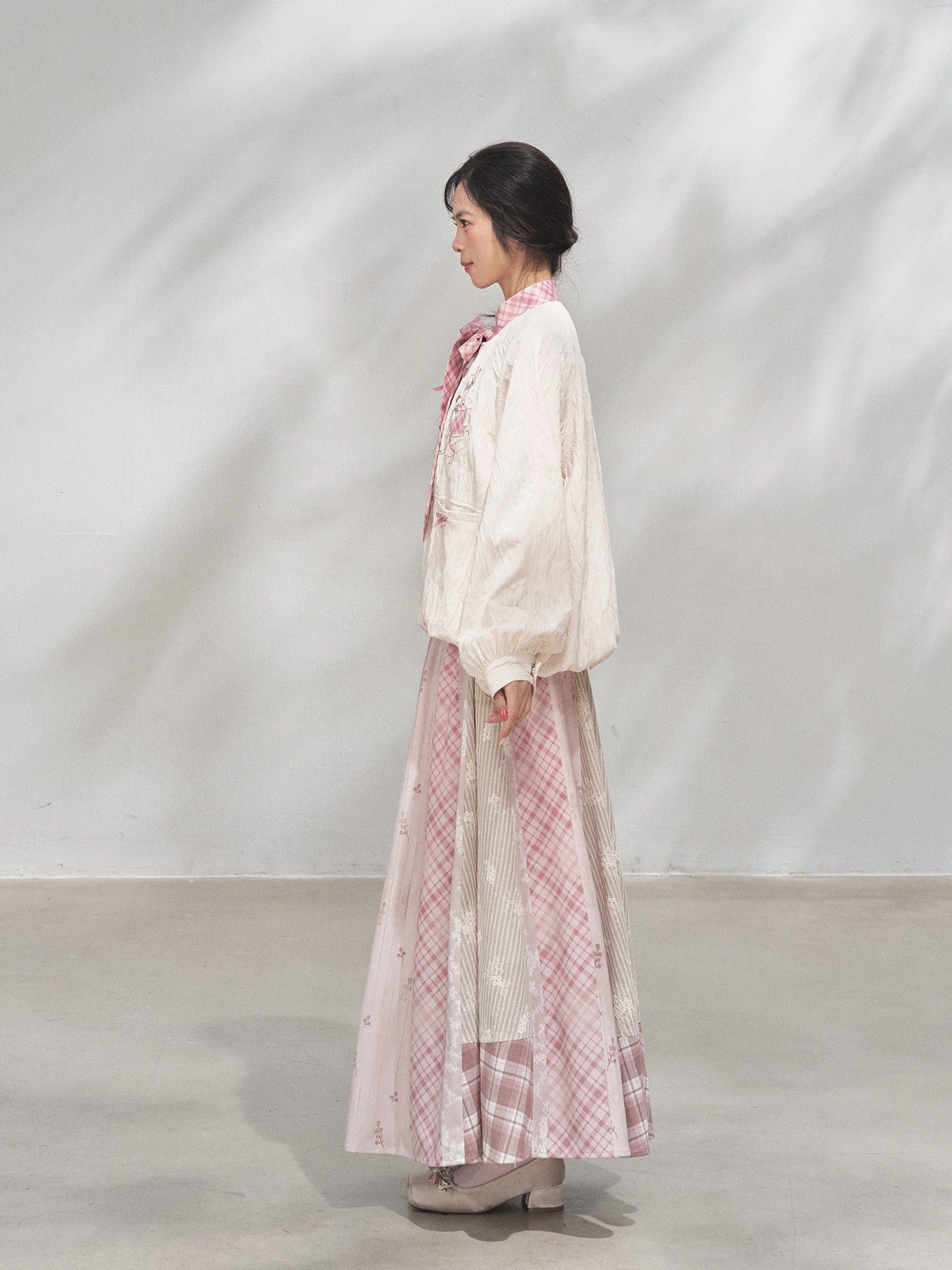 Right side view of a relaxed modern Hanfu xianxia coat and long patchwork maxi skirt showing the graceful drape and flowing silhouette