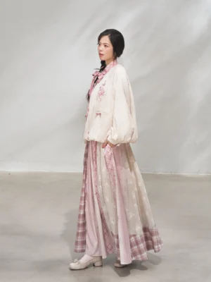 Side view of a modern Hanfu xianxia outfit showing the cropped coat hidden button closure, pink plaid details, and flowing coordinated skirt