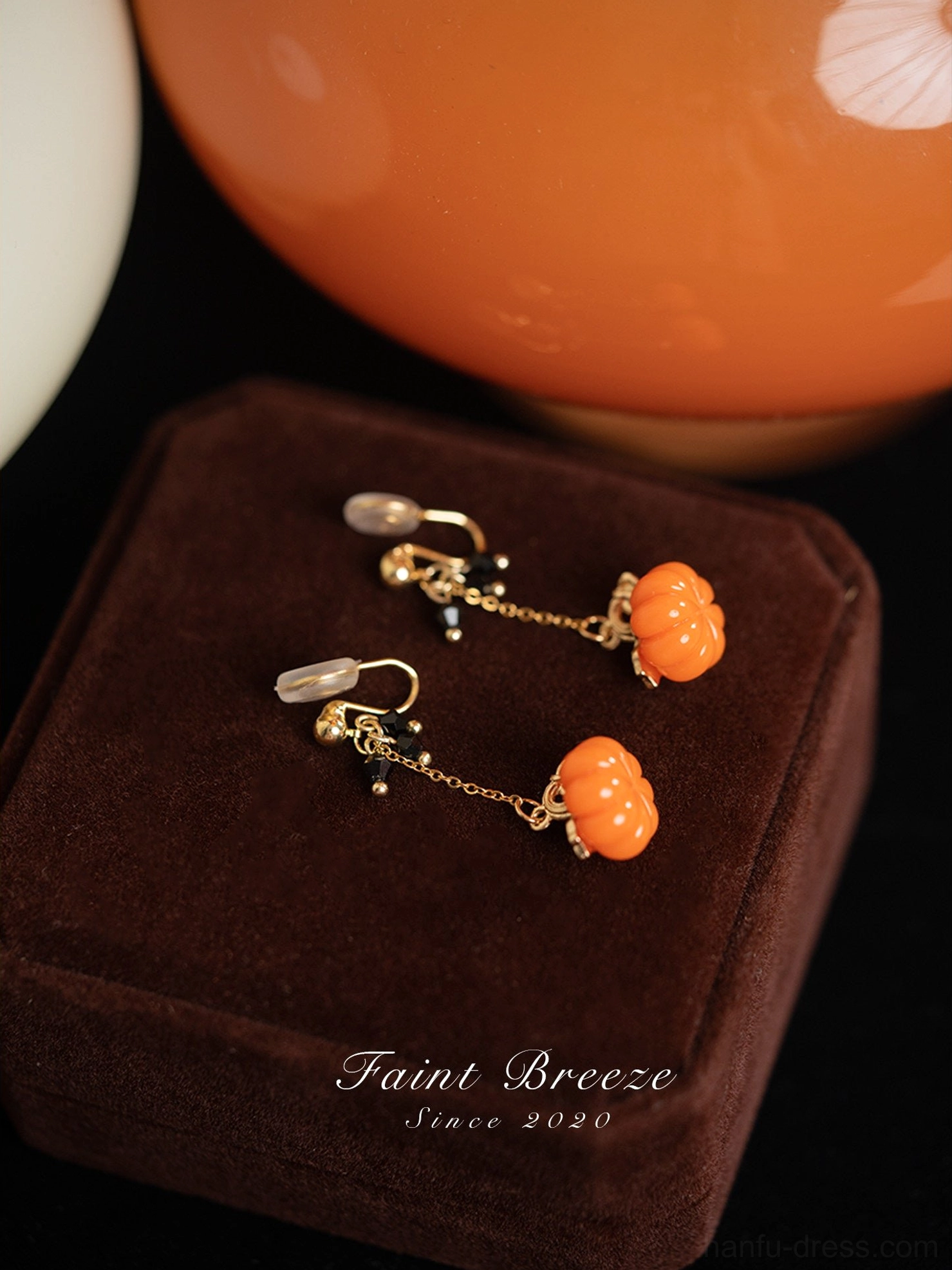 Comfort clip on pumpkin lantern Chinese earrings with clear clip pads, orange pumpkin charms, gold chains, and black decorative beads