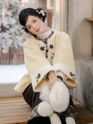 Close-up of Puppet Custard Chinese style cream winter coat with frog buttons plaid lining and soft pale trim