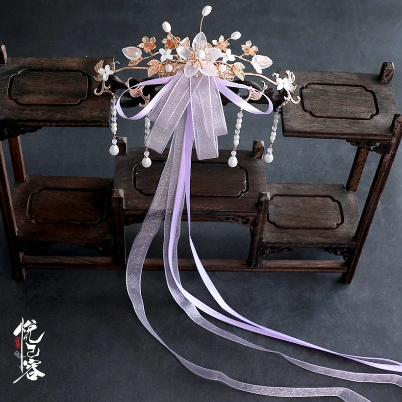 Purple Chinese traditional back hair pin displayed flat with long sheer ribbon, flower decorations, and crystal tassels