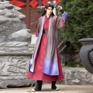 Full-body side-front view of a men's Hanfu Ghost King costume with purple gradient cross-collar robe, embroidered collar, matching belt, ghost mask styling, and traditional hair crown in an ancient courtyard