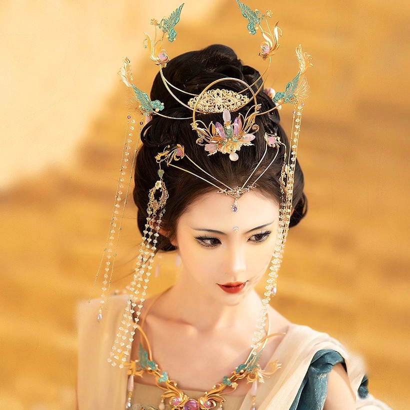 Close-up of a purple Dunhuang Hanfu hair crown with symmetrical blue phoenix motifs, central purple floral gemstone ornament, and long hanging crystal bead tassels