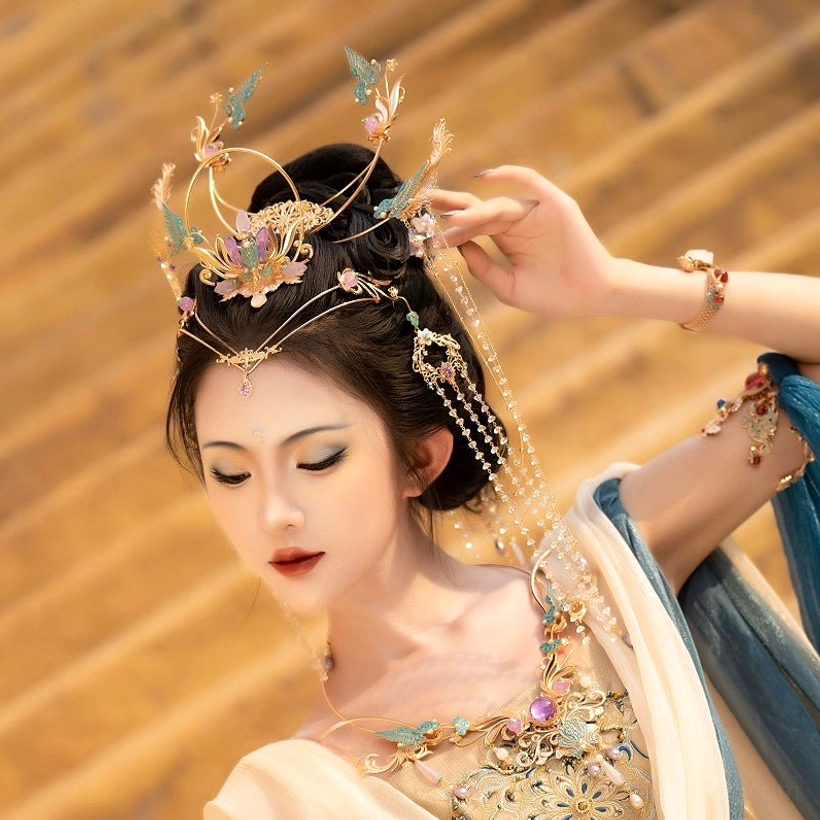 Side view of a purple Dunhuang Hanfu hair crown set with layered floral and bird ornaments, pearl-style beads, crystal tassels, and matching traditional dance styling
