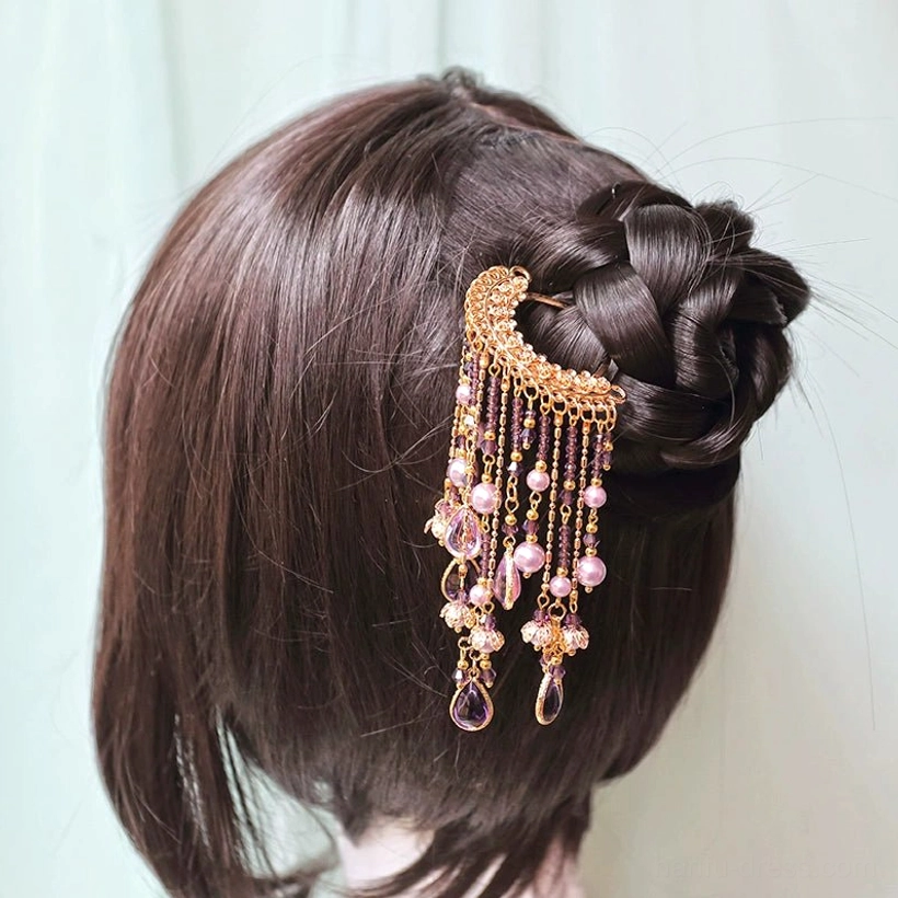 Purple and gold Chinese Hanfu tassel hairpin secured in a traditional coiled bun hairstyle on a dark brown wig