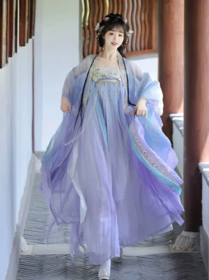 Purple gradient Tang Dynasty Hanfu Heziqun dress shown in a wooden corridor with flowing chiffon sleeves, embroidered bodice trim, wide outer shawl, and long trailing ribbons