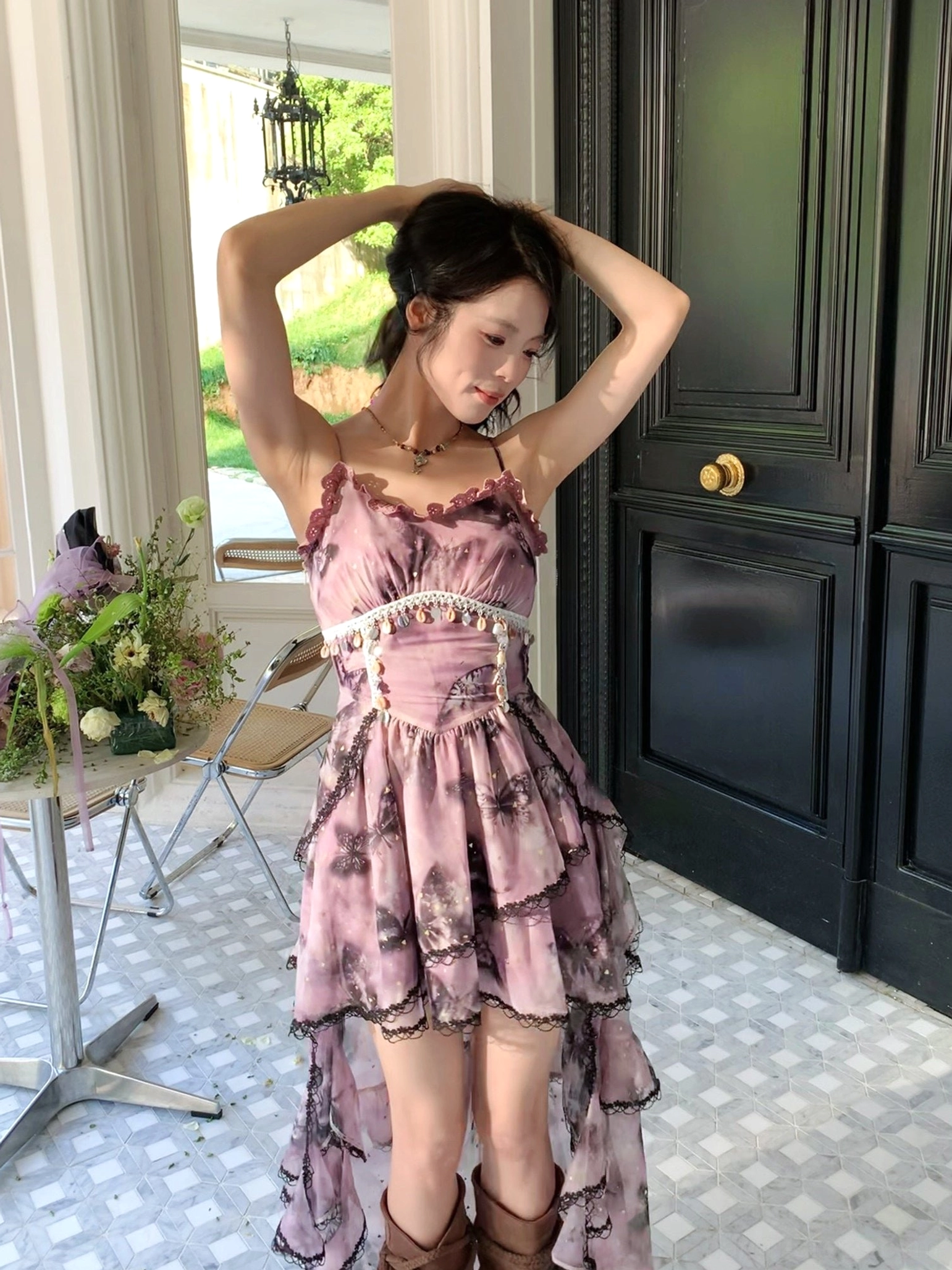 Purple high-low hem modern Hanfu slip dress with layered ruffles, beaded corset waist, and ink-wash butterfly print styled against a dark green vintage door