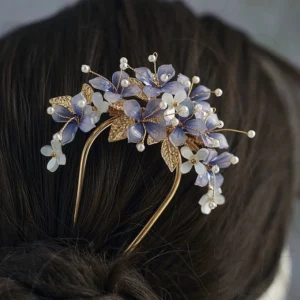 Purple hydrangea Chinese Hanfu hair pin worn in a dark brown coiled bun with gold leaves, white flowers, and pearl embellishments