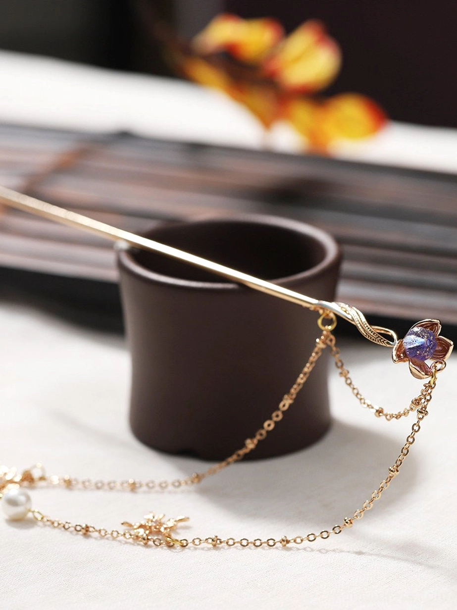 Purple lotus Chinese hair stick with long double-layer tassels, pearl pendants, snowflake charms, and twisted gold-tone hairpin shaft
