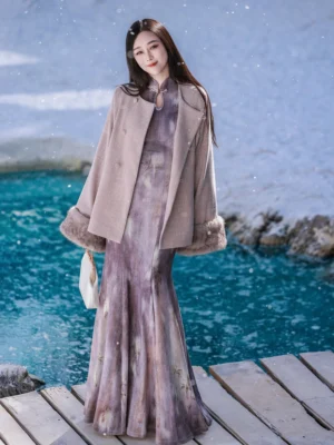 Purple mist modern qipao mermaid cheongsam dress and cropped fur collar jacket worn together beside a snowy turquoise lakeside