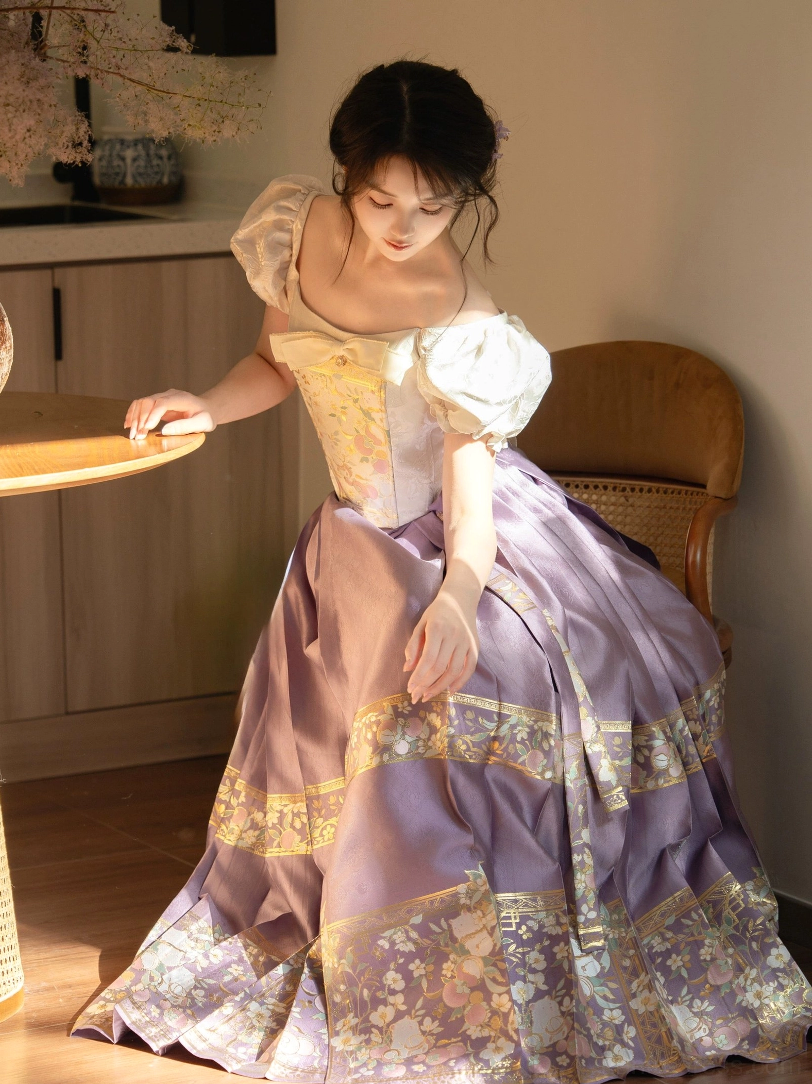 Purple modern Hanfu inspired outfit featuring an embroidered off shoulder puff sleeve corset and long satin style skirt with gold floral patterns