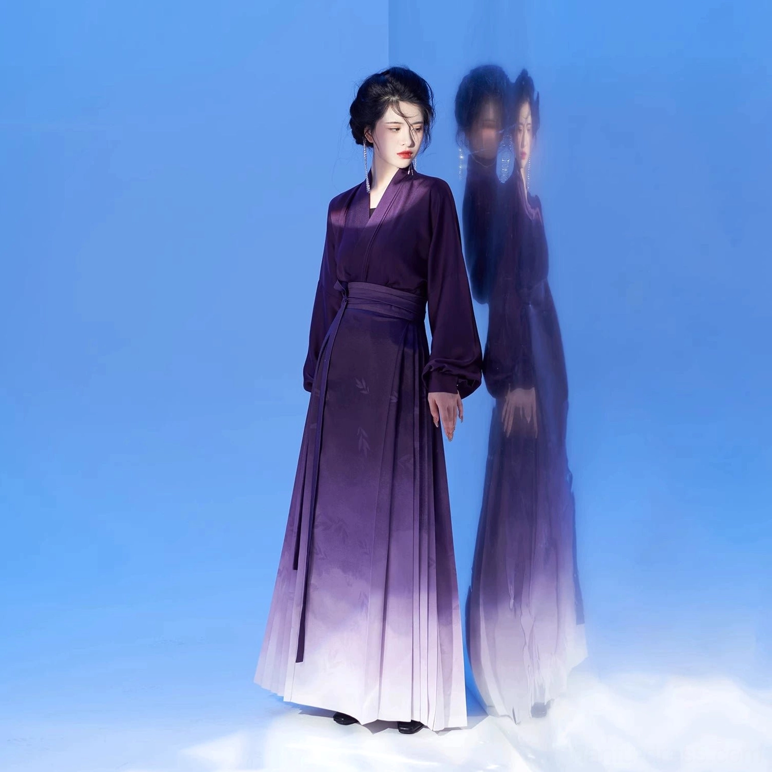 Full-body front view of purple ombre Ming Dynasty Hanfu mamianqun outfit with high-waisted pleated skirt in blue studio setting