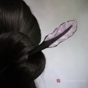 Purple translucent feather Chinese hair stick worn in a dark coiled updo, elegant Hanfu hairstyle accessory back view