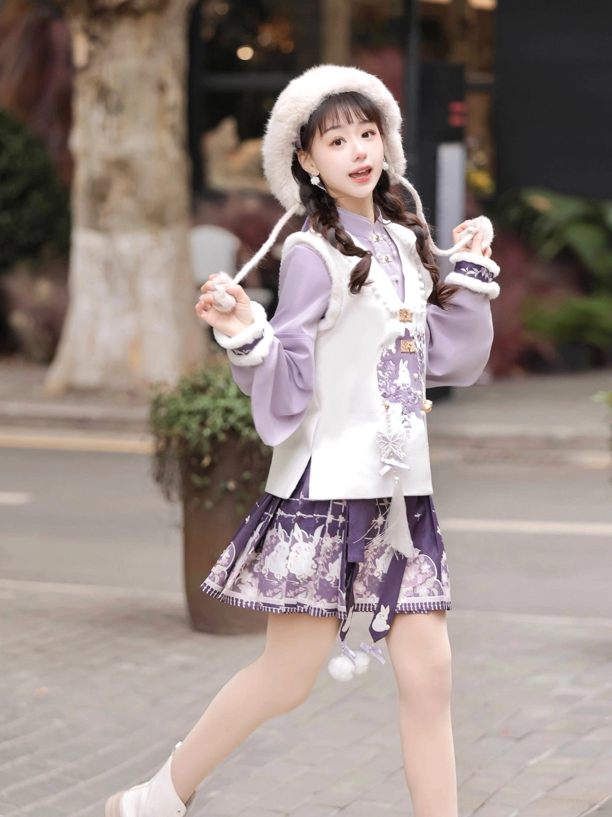 Side view of a purple and white Ming-inspired Hanfu set featuring pipa sleeves, rabbit vest embroidery, tassels, and pom-pom skirt ornaments