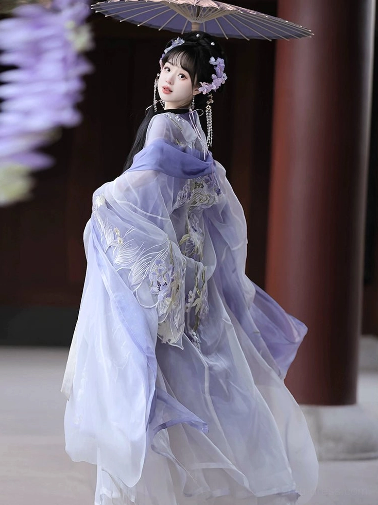 Back three-quarter view of a purple and white Tang Dynasty Hanfu Heziqun dress set with embroidered sheer robe, floral hair accessories, and traditional umbrella