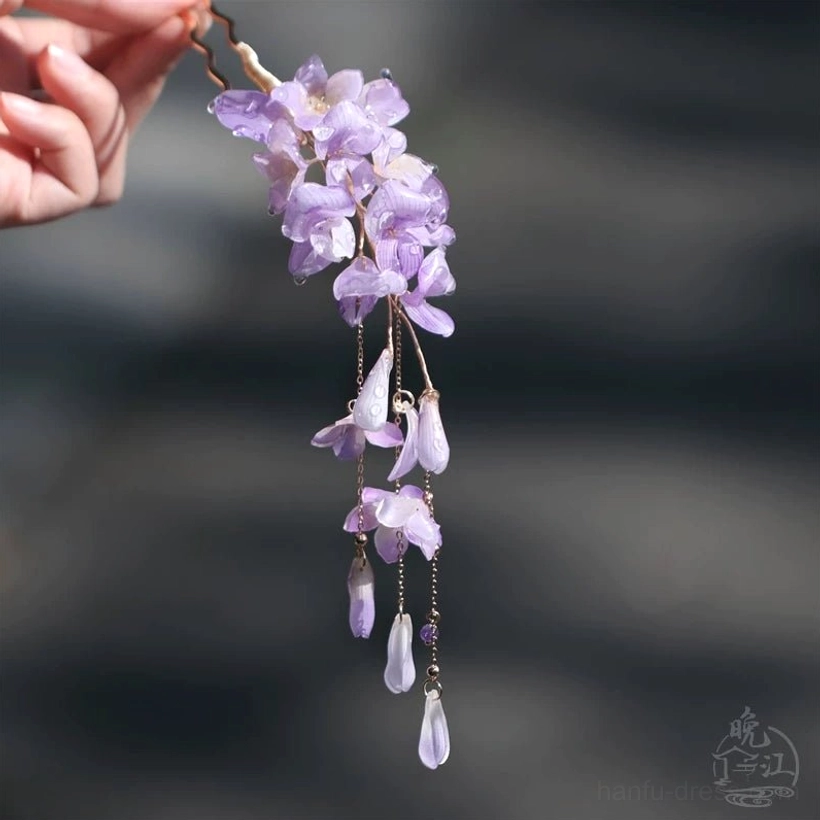 Close view of purple wisteria floral Chinese hair stick with metal pin base, cascading violet blooms, and matching teardrop tassel charms