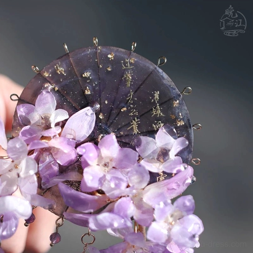 Purple wisteria Chinese hair stick held in hand with dark fan-shaped panel, gold foil detail, cascading crystal tassels, and traditional Hanfu hair accessory design