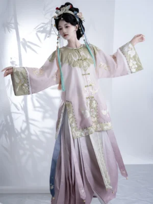 Side view of Qing Dynasty Han women’s pink embroidered robe-style top and flowing wrap skirt with traditional hair accessories
