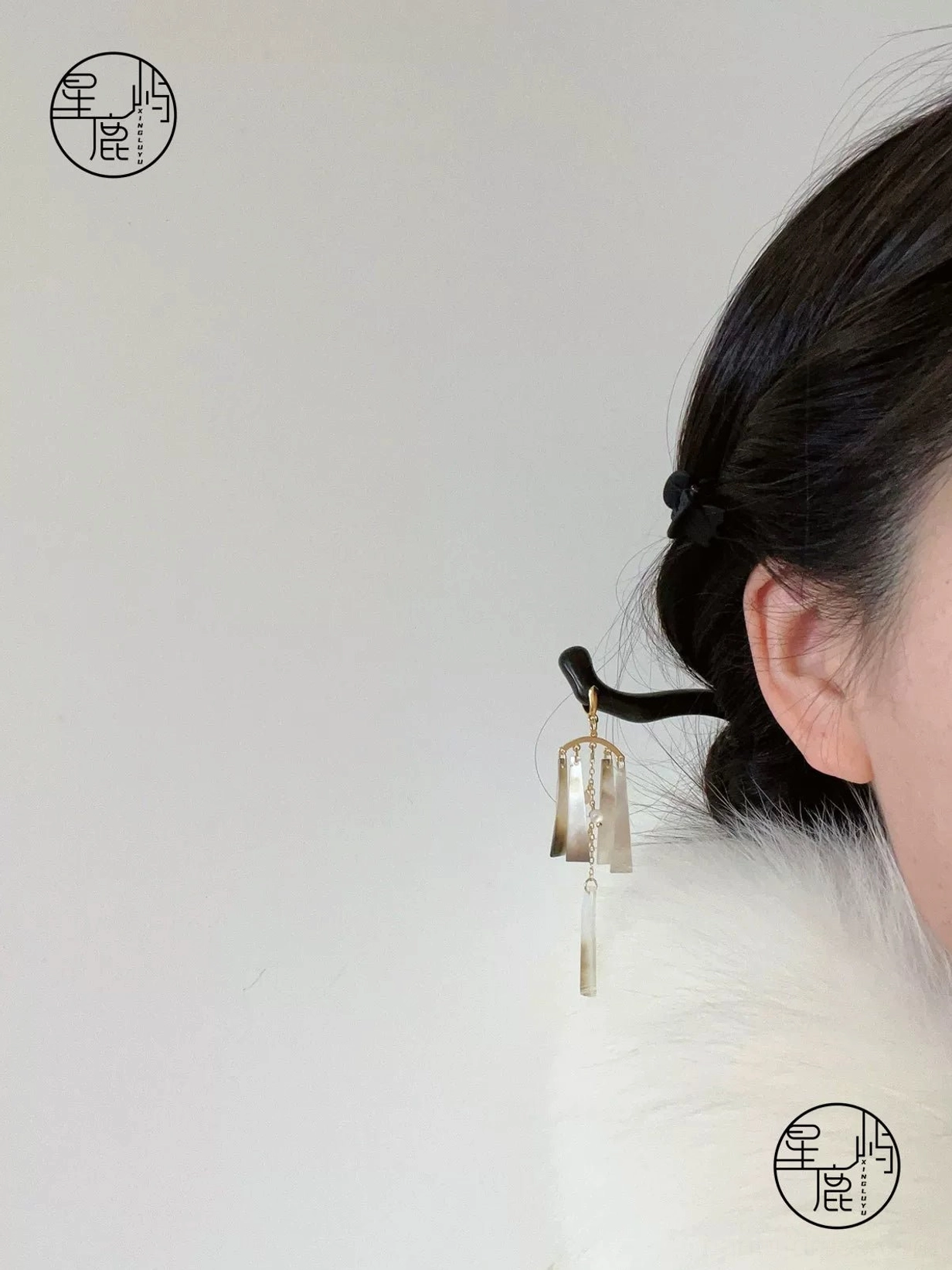Model wearing Qingfeng mother-of-pearl tassel Chinese hair stick in a traditional Hanfu-inspired updo