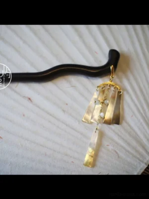 Side view of Qingfeng traditional Chinese hair stick featuring dark curved pin, pearl-like tassel pendant and bead details