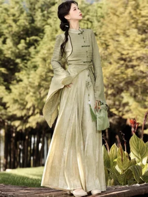 Qingti matcha green modern Hanfu top and gradient beige wide-leg pants worn as a New Chinese Style outfit in an outdoor forest setting