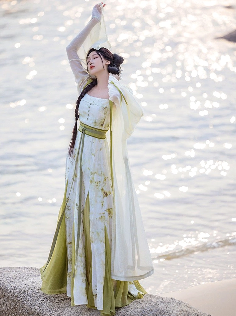 Qingyuan botanical print Hanfu dress and oversized sheer robe with wide sleeves photographed on seaside rocks