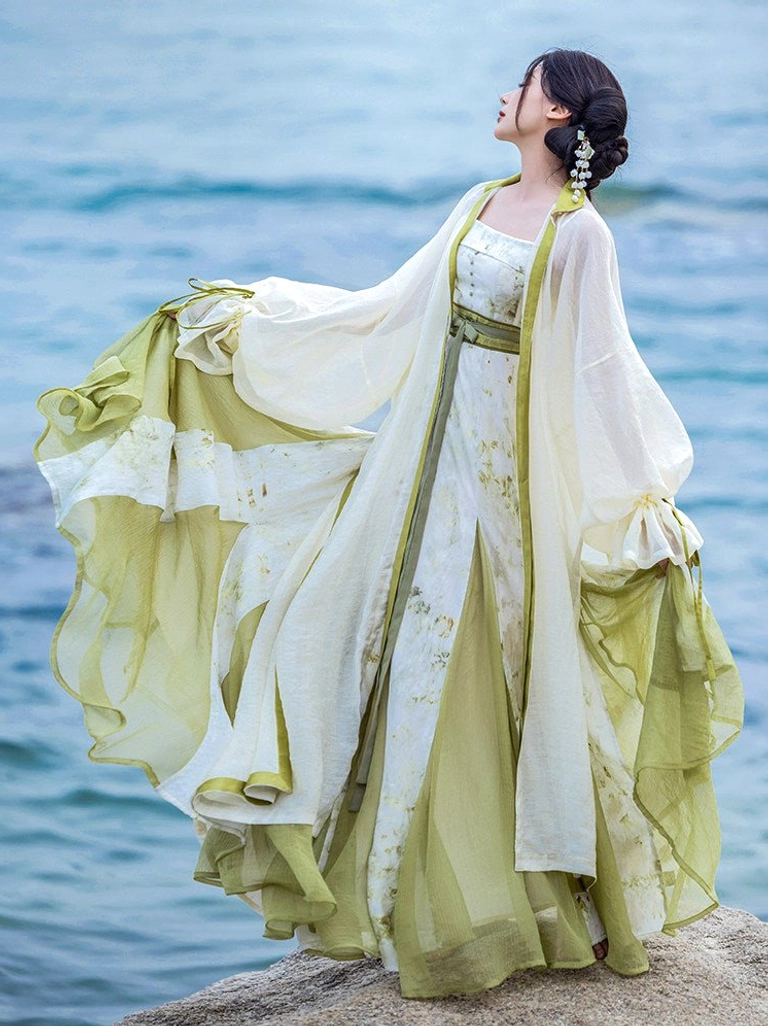 Qingyuan botanical tie-dye modern Hanfu dress and sheer long robe set shown from side back on a rocky seaside beach