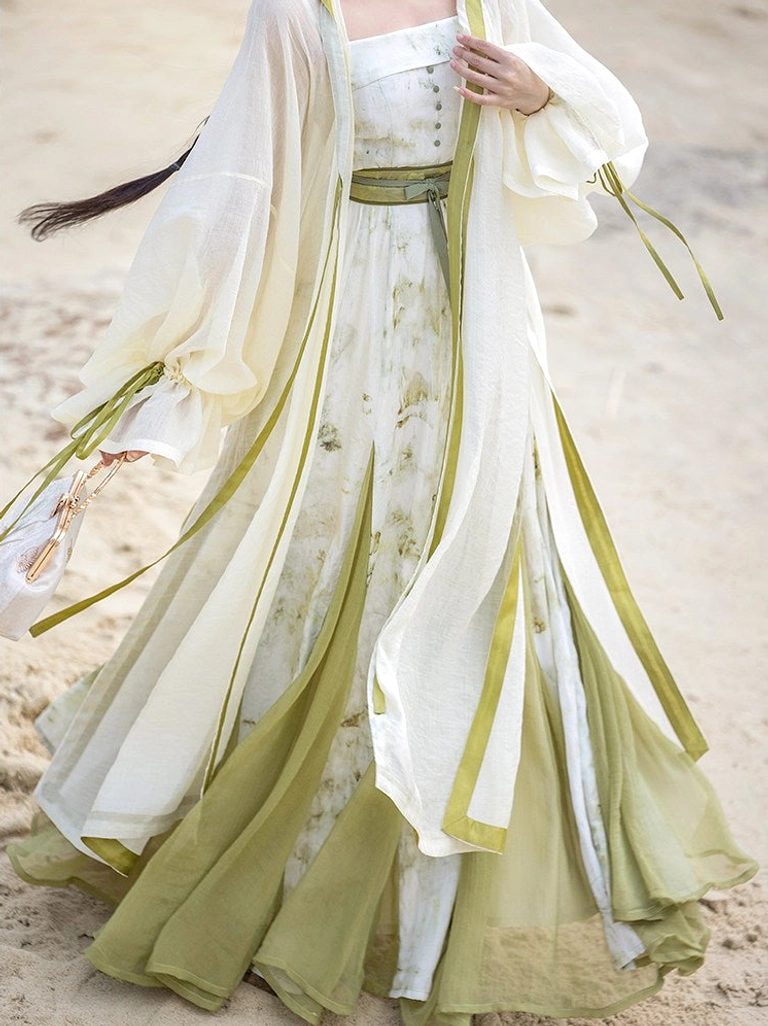 Detail view of Qingyuan modern Hanfu set showing detachable sage green waist sash layered skirt and sheer wide sleeve robe