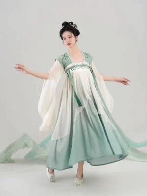 Full-body front view of Qintaoluoge Tang Dynasty modern Hanfu dress with ivory to sage green gradient, floral embroidered shoulder yoke, wide flowing sleeves, and elegant traditional Chinese styling