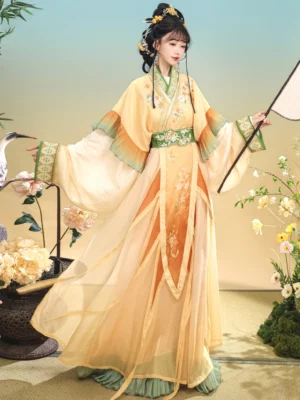 Rear three-quarter view of Qiuxiang Wei Jin Dynasty Hanfu with flowing chiffon skirt, embroidered green waist belt, gradient sleeve cuffs, and layered traditional Chinese costume details