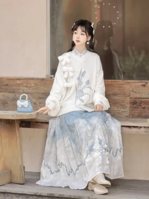 Rabbit cloud modern Hanfu sweater and blue Mamianqun horse face skirt set worn in an outdoor cafe setting