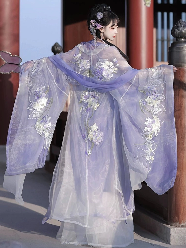 Rear view of a purple gradient Tang Dynasty Hanfu with wide sheer embroidered sleeves, floral outer robe, and matching waist sash