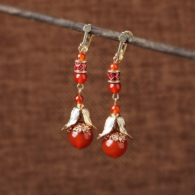 Red agate Chinese dangling earrings with comfortable clip-on closure, layered red beads, and gold-tone floral details