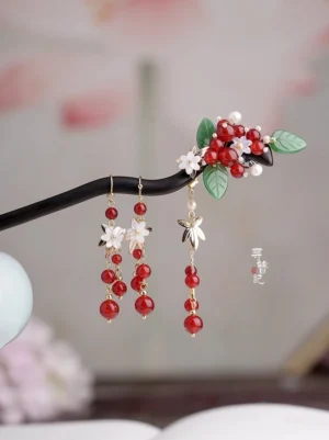 Red bean Hanfu hairpin and matching dangle earrings with dark wooden base, red berry beads, green leaves, white flowers, and gold-tone details