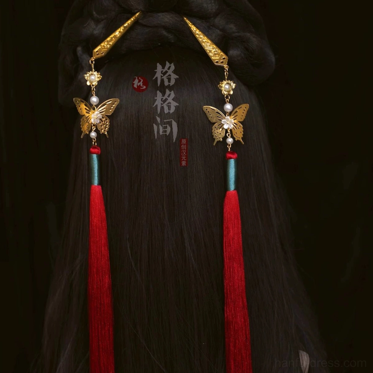 Red Chinese butterfly tassel hair pins with gold-tone ornaments styled in a traditional black hair bun