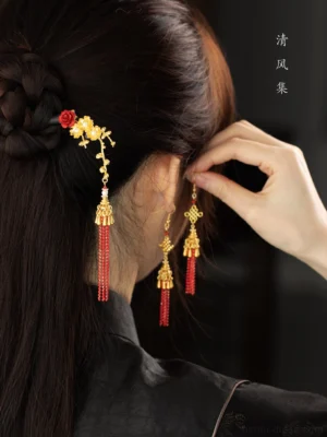 Hanfu hairstyle styling with red Chinese knot tassel earrings and matching floral hairpin shown from side back