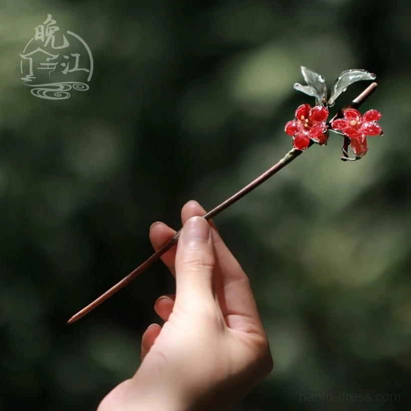 Handheld close-up showing the overall size and detailed red crabapple flowers, grey-green leaves, and brown stick of this Chinese Hanfu hair accessory