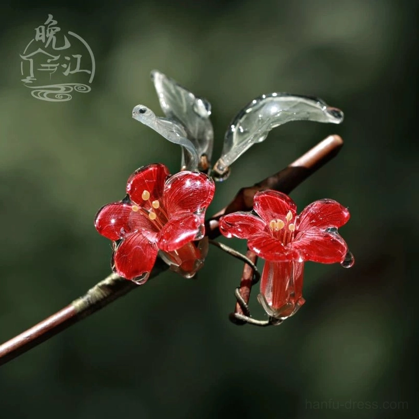Close-up side view of a red crabapple flower Chinese hair stick with translucent resin petals, grey-green leaves, glossy water-drop texture, and brown wooden-style stick