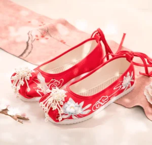 Red embroidered traditional Chinese Hanfu shoes with lotus crane cloud motifs beaded tassels ankle tie straps and white rubber soles