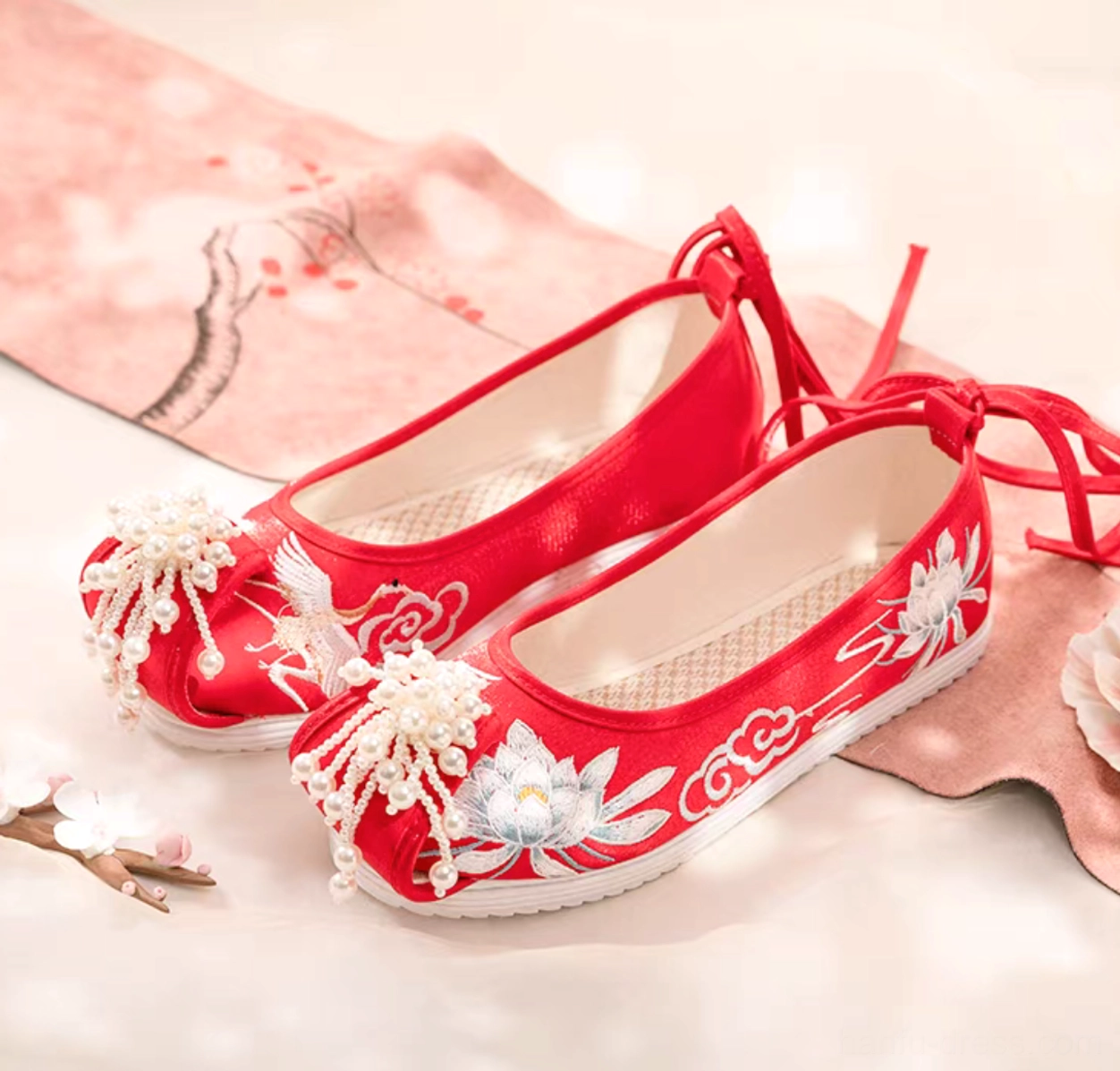 Red embroidered traditional Chinese Hanfu shoes with lotus crane cloud motifs beaded tassels ankle tie straps and white rubber soles