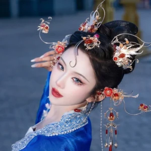 Side view of ornate Chinese Hanfu hair ornaments with gold metalwork red flowers dangling bead chains and tassels