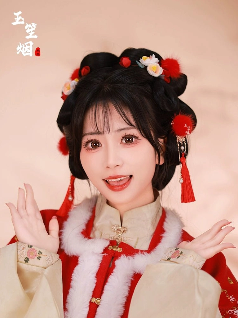 Model wearing red furball Hanfu hair pins with tassels in a traditional coiled hairstyle and red beige Chinese Hanfu outfit