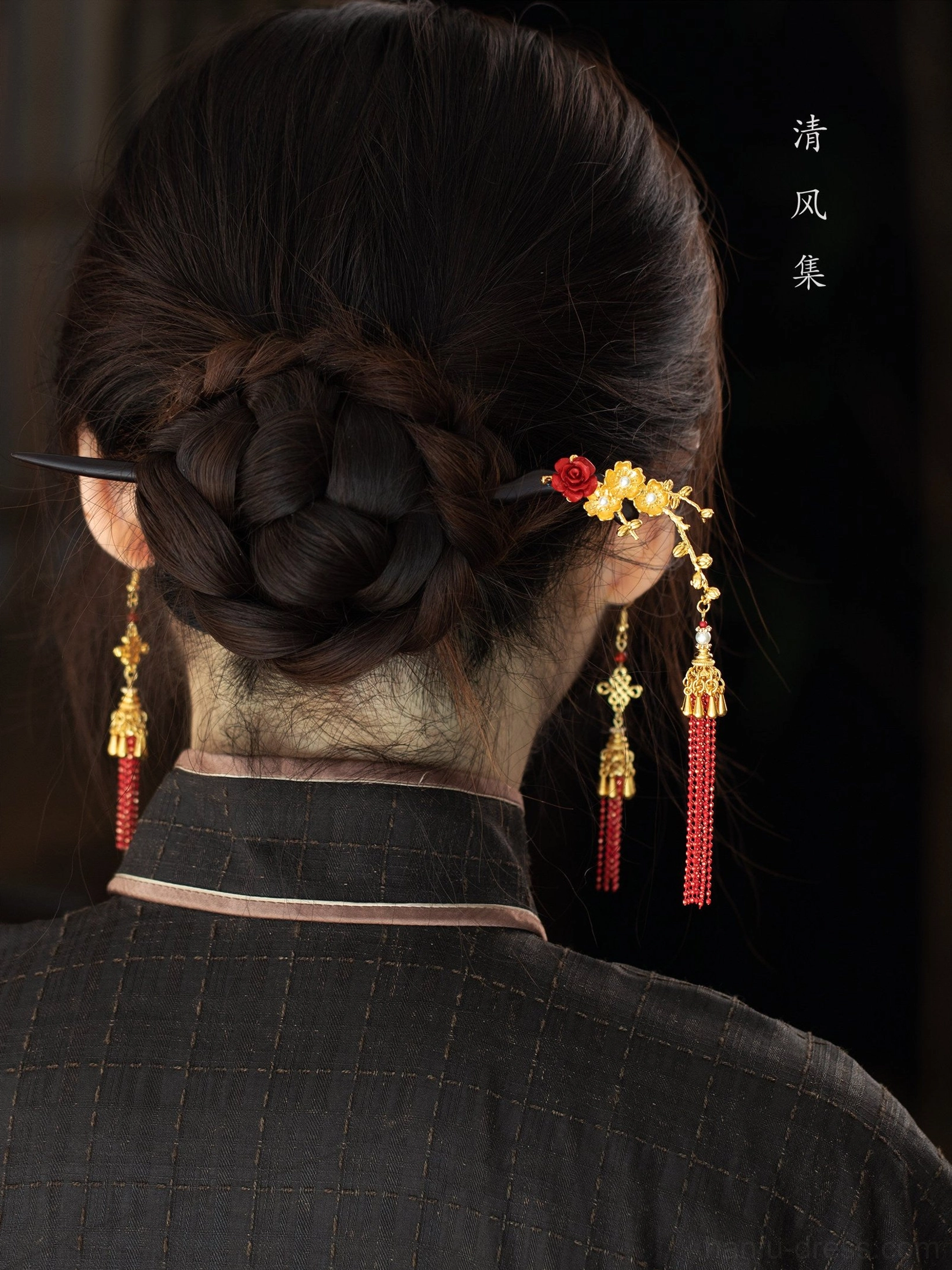 Back view of braided Hanfu bun styled with red gold Chinese tassel earrings and floral hair accessory