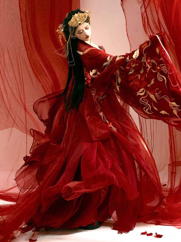 Side three-quarter view of a red bridal Hanfu Heziqun dress with wide sleeves decorated with golden floral vine embroidery and a layered ruffled floor-length skirt