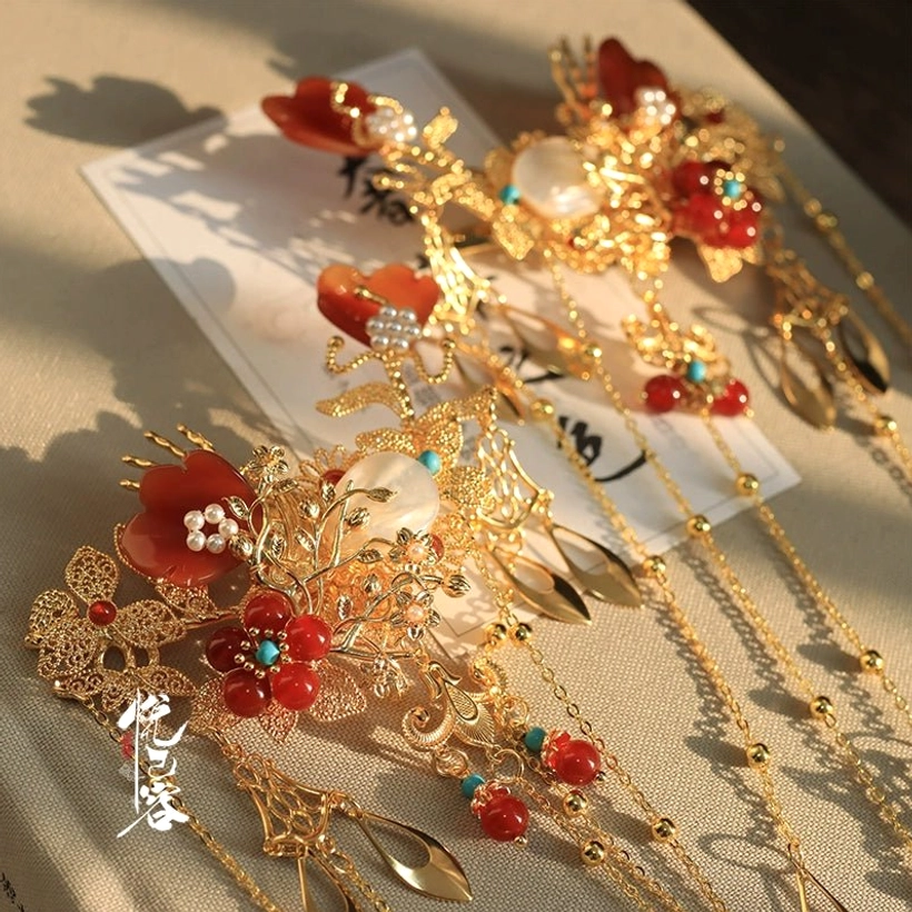 Traditional Chinese Hanfu hair ornament set with red lantern beads gold floral frames pearls and long tassel chains flat lay