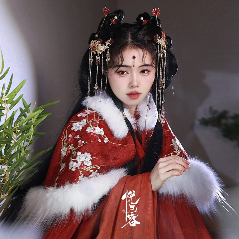 Red lantern tassel hair pins decorating a double bun hairstyle with red Hanfu and white fur collar for festive traditional styling